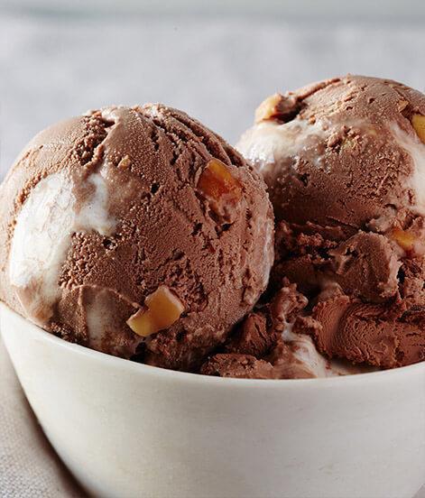 Rocky Road Ice Cream · Velvety swirls of marshmallow, roasted almonds, and our legendary chocolate ice cream come together in this playful ice cream delight. 

