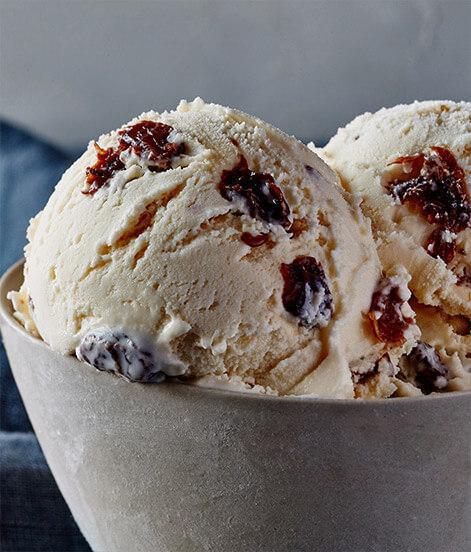 Rum Raisin Ice Cream · We soak plump raisins in rum and add pure, sweet cream for a rich, flavorful experience infused with just the right hint of warmth. 

