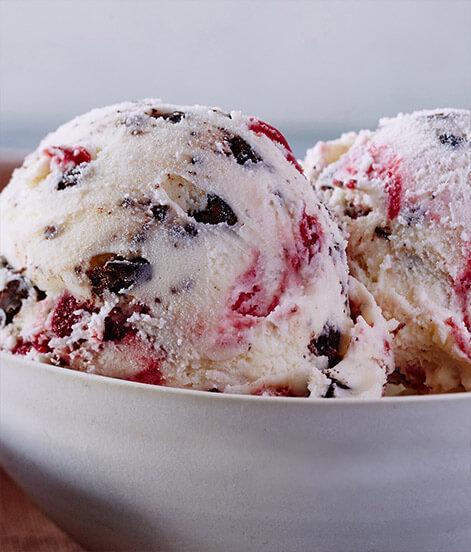 White Chocolate Raspberry Truffle Ice Cream · A truly exquisite ice cream inspired by fine chocolate truffles. We begin with pure white chocolate ice cream and swirl in satisfying chunks of chocolaty fudge truffles and a tangy raspberry ribbon. 

