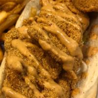 Catfish PoBoy · Seasoned Corn Meal dusted Catfish on a French Roll with Lettuce, Tomatoes, Pickle and Cajun ...