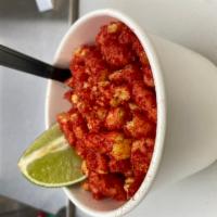 Flaming Hot Mexican Street Corn In A Cup · Sweet White corn topped with lime infused mayonnaise, Cojita cheese, Flaming Hot Cheetos Cru...