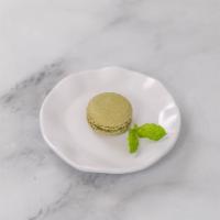 Pistachio Macaron · Sage green shell with crushed pistachio buttercream.
