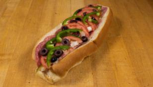 Genoa and Provolone Italian Sub · seasoned Italian salami. Served with American cheese, onions, pickles, tomatoes, green peppers, olives, salt, pepper and oil. Fresh baked bread daily.

