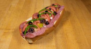 Cold Cut Italian Sub · Genoa salami, capicola, prosciutto and Provolone. Served with American cheese, onions, pickles, tomatoes, green peppers, olives, salt, pepper and oil. Fresh baked bread daily.