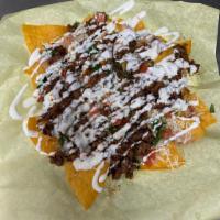 Super Nachos · Choice of:  carnitas, chicken, ground beef or pastor, loaded with beans, cheese, guacamole, ...