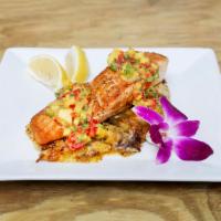 Grilled Salmon · Grilled Atlantic Salmon topped with our mango mojo, served w/ sweet mashed plantains.