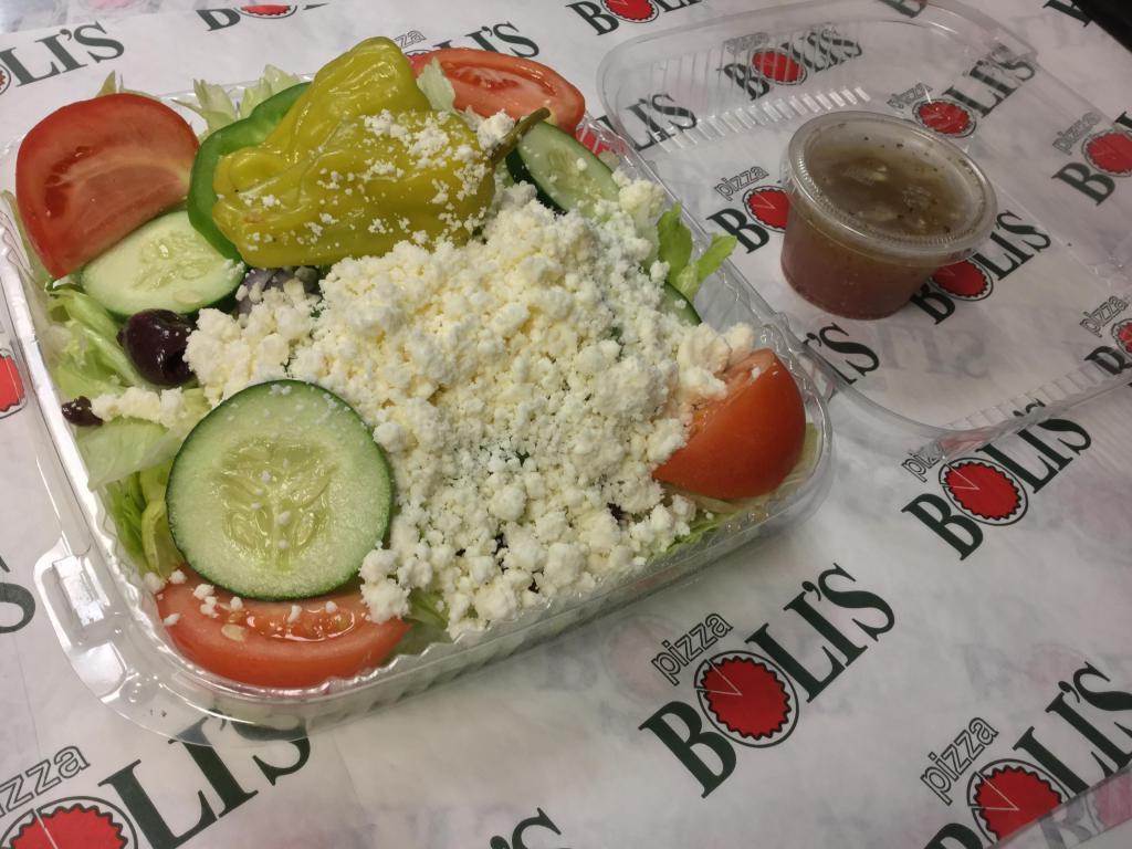 Greek Salad · Mixed lettuce, green pepper, tomato wedges, red onion, cucumbers, kalamata olives, pepperoncini, feta cheese and served with a side of house dressing.