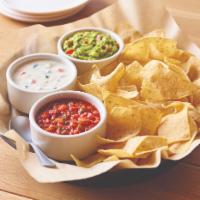 Classic Dip Trio · Freshly made white corn tortilla chips served with our chipotle lime salsa, melty white ques...