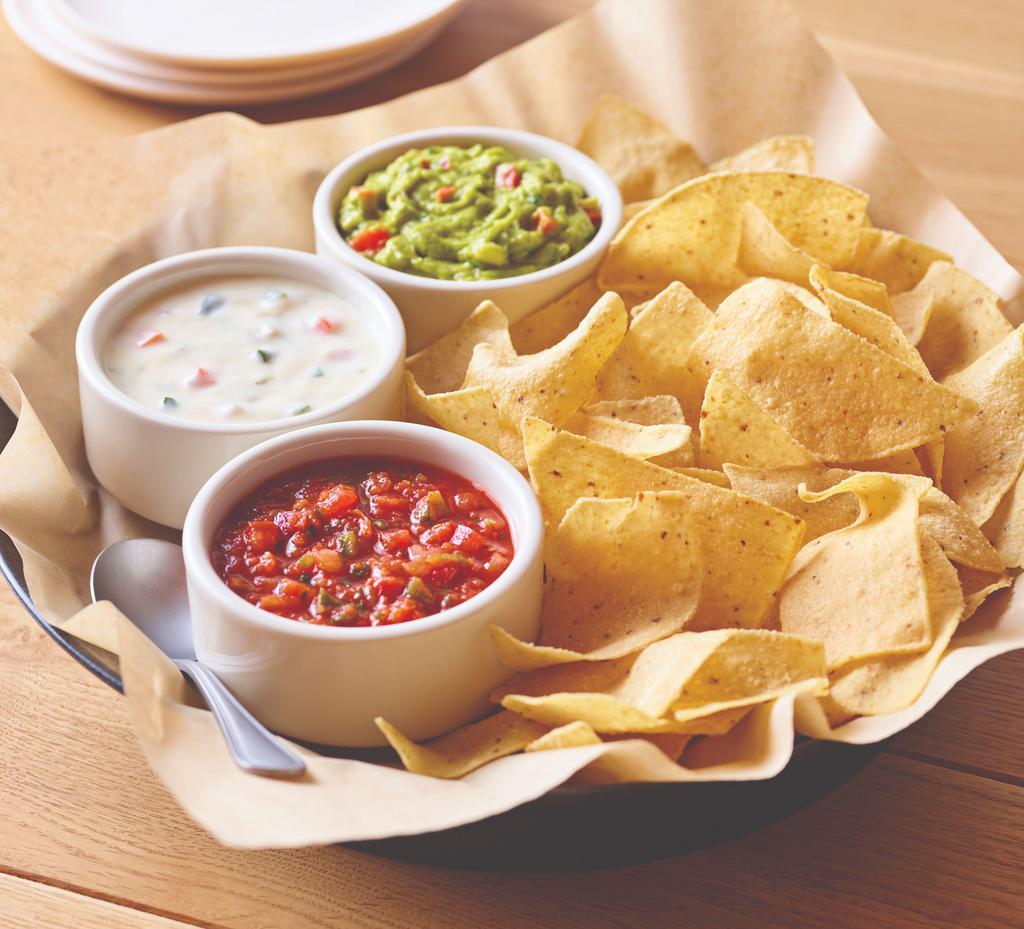 Classic Dip Trio · Freshly made white corn tortilla chips served with our chipotle lime salsa, melty white queso and guacamole. Gluten-sensitive.