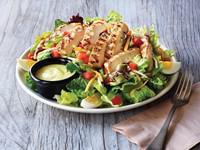 Grilled Chicken Tender Salad · A hearty salad with grilled chicken tenders on a bed of fresh greens topped with a blend of ...