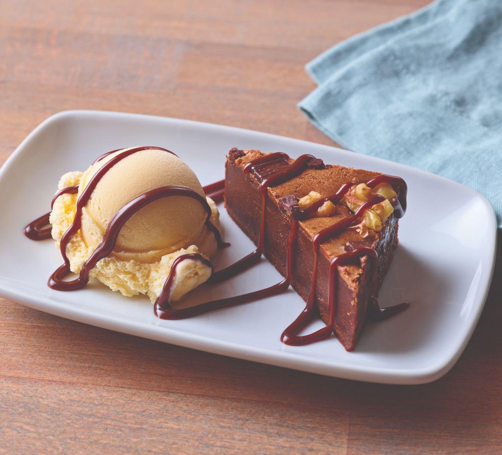 Brownie Bite · The perfect size of a warm dark chocolate brownie with nuts. Served with vanilla ice cream and drizzled with hot fudge.