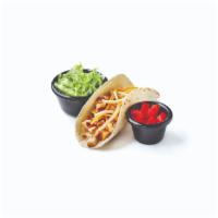 Kid's Chicken Taco · A soft flour tortilla shell filled with chopped chicken and Cheddar cheese. Served with lett...
