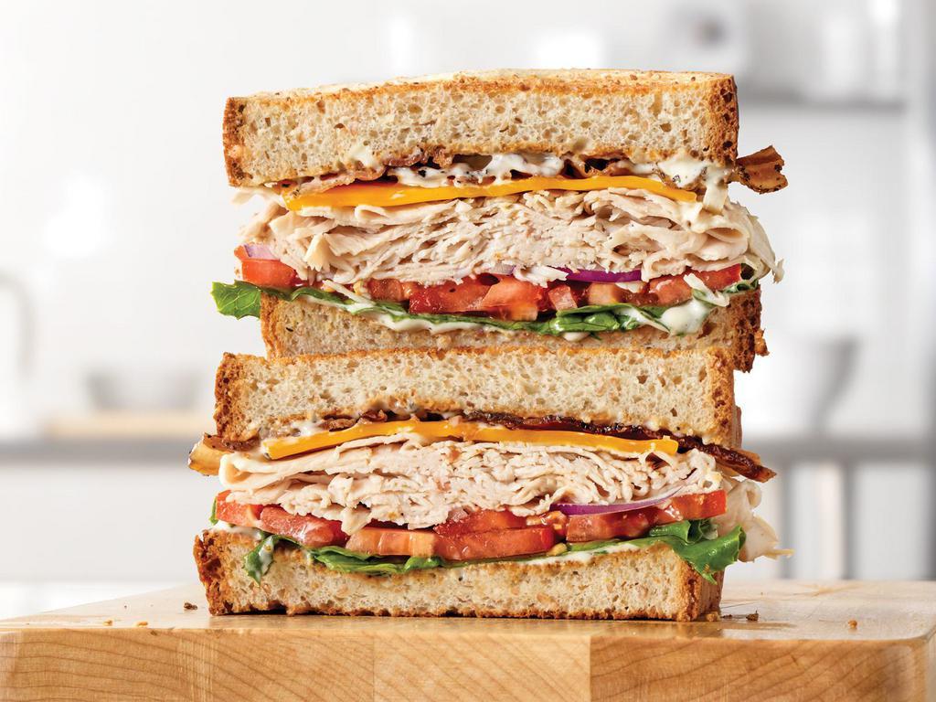 Market Fresh® Roast Turkey Ranch & Bacon Sandwich Small Meal · Premium sliced turkey breast with pepper bacon, Cheddar cheese, green leaf lettuce, tomato, red onion and parmesan peppercorn ranch sauce on sliced honey wheat bread. Visit arbys.com for nutritional and allergen information.