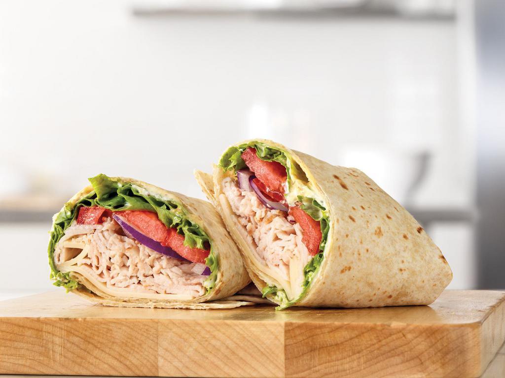 Roast Turkey & Swiss Wrap Combo · Sliced roast turkey with Swiss cheese, lettuce, tomato, red onion, spicy brown honey mustard and mayo in a hearty grain wrap. Meal includes choice of side and drink. Visit arbys.com for nutritional and allergen information.