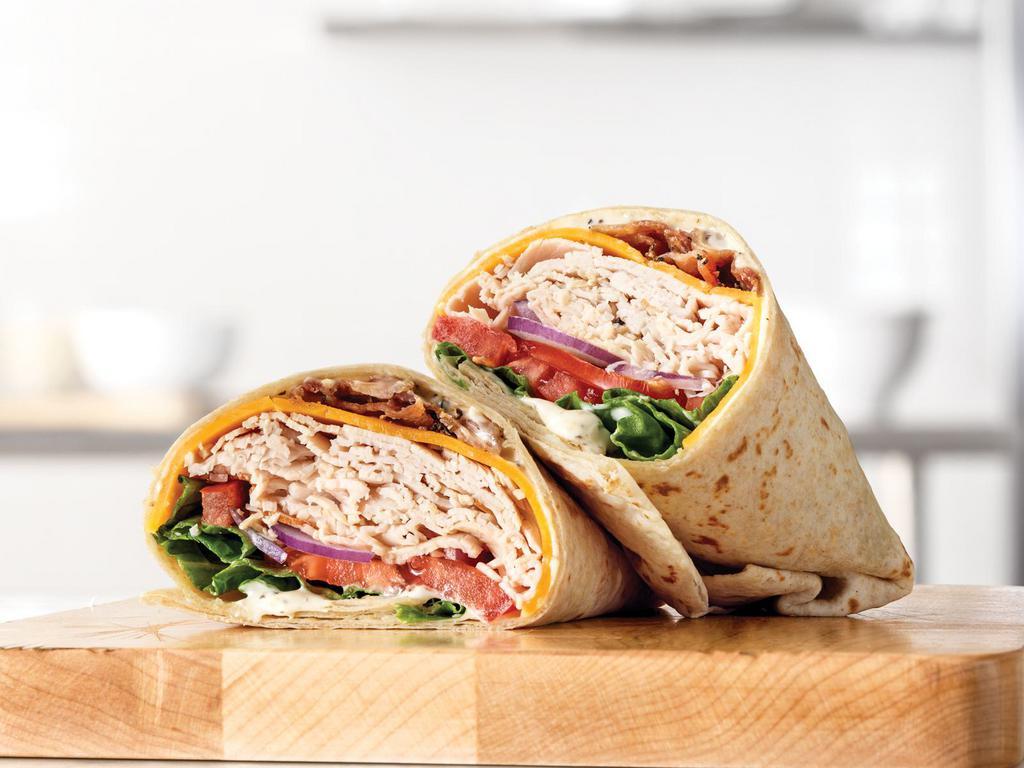 Market Fresh® Roast Turkey Ranch & Bacon Wrap · The Roast Turkey Ranch & Bacon comes with roast turkey, peppercorn ranch sauce and thick-cut pepper bacon. It also has Cheddar cheese and is wrapped in a soft hearty grain wrap. We tried adding those ingredients to the name, but the Roast Turkey Ranch & Bacon on a hearty grain wrap is a ridiculous name for a wrap.
