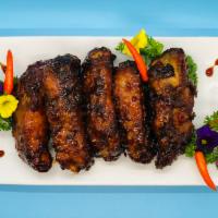 Baby Back Ribs · 5 Deep fried pork baby back ribs battered in tempura and sauteed in house BBQ sauce