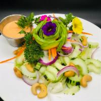 English Cucumber and Avocado Salad · Lettuce, red onions, shredded carrots, cucumbers, cashews, avocado, roasted peanuts, and hou...