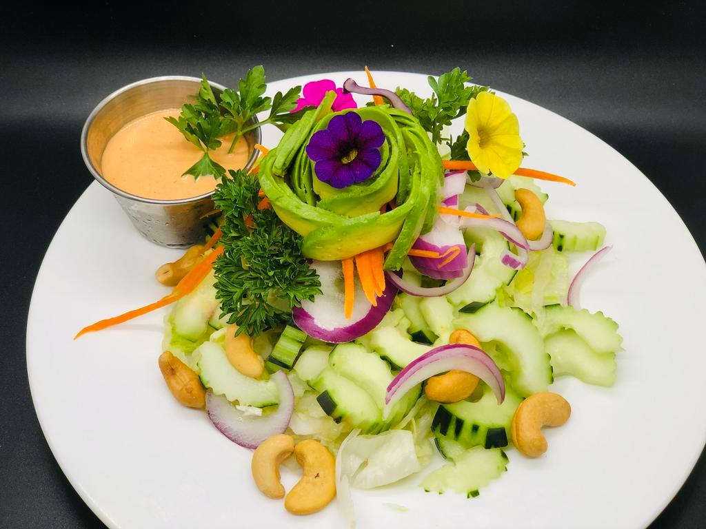 English Cucumber and Avocado Salad · Lettuce, red onions, shredded carrots, cucumbers, cashews, avocado, roasted peanuts, and house vinaigrette dressing.