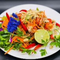 Papaya Salad · Shredded green papaya, tomatoes, green beans, carrots, lettuce roasted peanuts, and Thai gar...