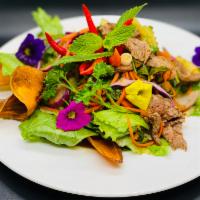 Thai Beef Salad · Mint, onions, carrots, cilantro, and Thai style lime vinaigrette dressing.