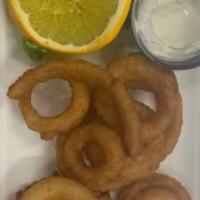 Onion Rings · Freshly made ring of onions dipped in batter and deep-fried to perfection, paired with a sid...