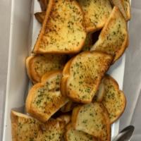 Garlic Bread · 2 pieces of our homemade freshly toasted Garlic Bread.