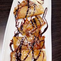 Deep Fried Caramelized Banana · Banana wrapped in spring roll deep fried with chocolate topping.