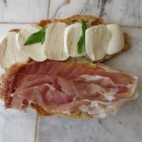 Crudo Sandwich · Prosciutto di parma, fresh mozzarella, basil, extra virgin olive oil.