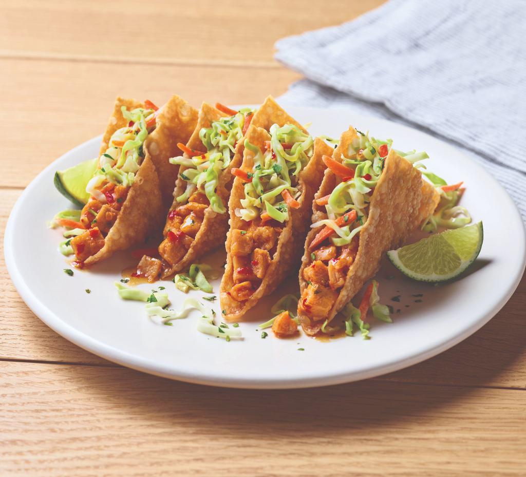 Chicken Wonton Tacos · A deliciously different way to the taco. Tangy grilled chicken, sweet Asian chile sauce and dumpling sauce stuffed into crispy wonton shells and topped with our signature coleslaw and cilantro.