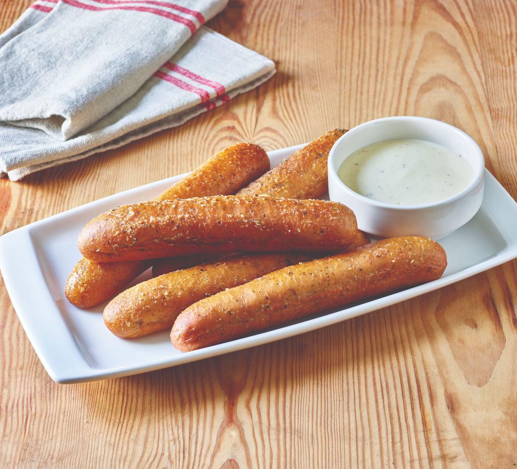 Breadsticks with Alfredo Sauce · Five golden brown signature breadsticks brushed with garlic and parsley butter. Served with creamy Alfredo sauce for dipping.