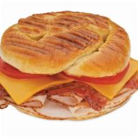 Turkey, Bacon and Cheddar Panini Sub · Oven-roasted turkey, crisp bacon, smoked cheddar and tomatoes with spicy mustard.