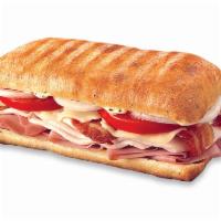Ultimate Club Panini Sub · Slow-cured ham, oven-roasted turkey, crisp bacon, Swiss, tomatoes and onion with peppercorn ...