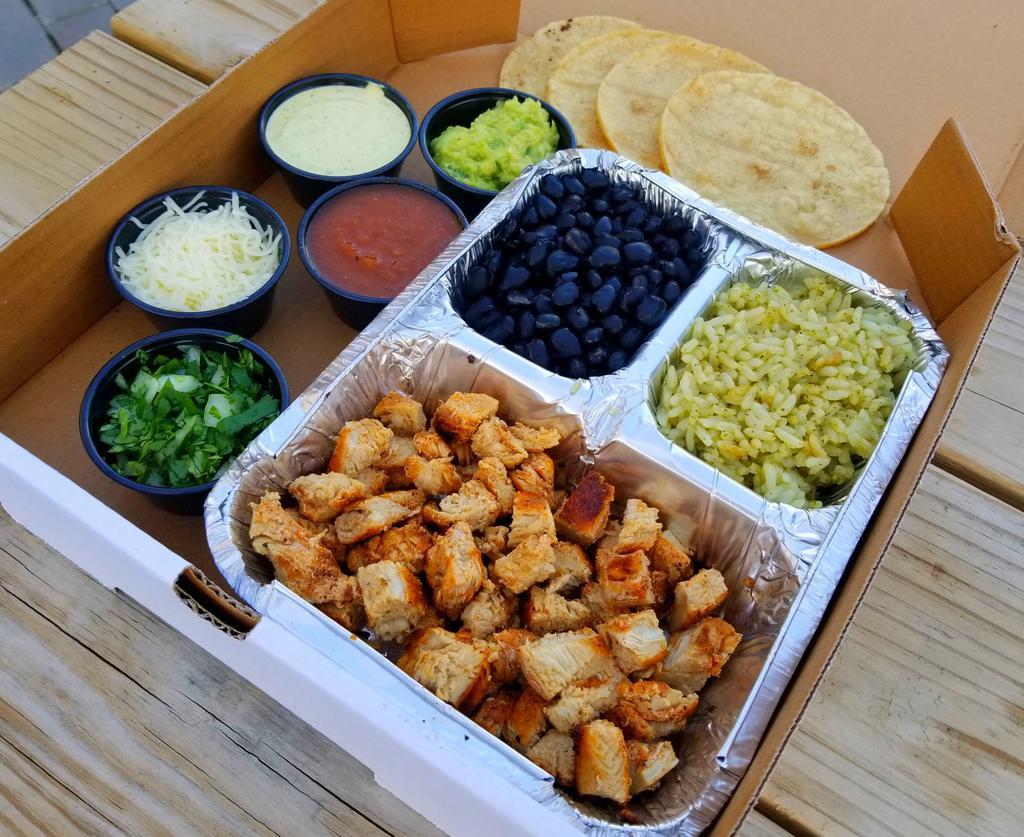 Grilled Chicken Personal Taco Box · Marinated Grilled Chicken, cilantro rice (vegan), seasoned black beans (vegan), fire roasted chile de arbol salsa, Mama Em’s Super Secret Cilantro Crema Sauce, Monterey Jack cheese, chopped cilantro with diced onions, and 4 tortillas. Serves one person.
