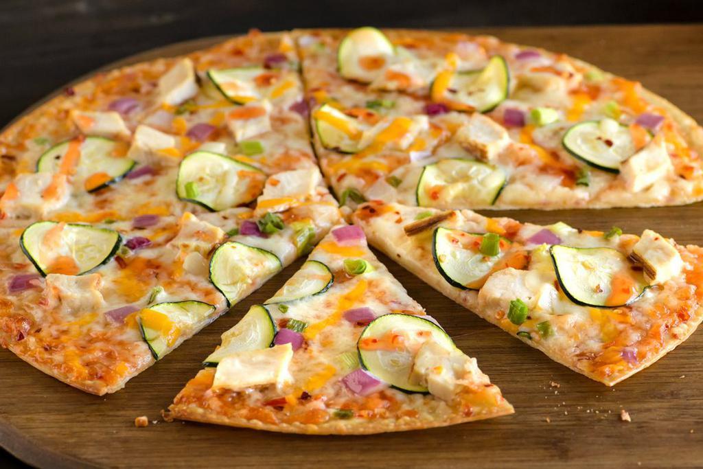Thai Chicken Pizza (Baking Required) · Sweet chili sauce, mozzarella, chicken, zucchini, mixed onions and crushed red pepper. Recommended on a thin crust.