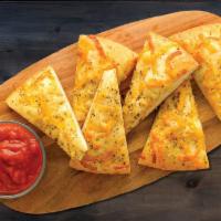 Classic Cheesy Bread (Served Uncooked-Baking Required) · Fresh dough, herb garlic spread, mozzarella, cheddar and a side of marinara.