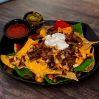 The Nachos · Made-to-order tortilla chips, red onions, queso, Jalapenos, olives, tomatoes and sour cream.