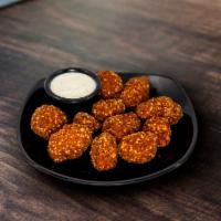 Sriracha Chicken Bites · Chicken battered with a sriracha sesame seed breading served with ranch.