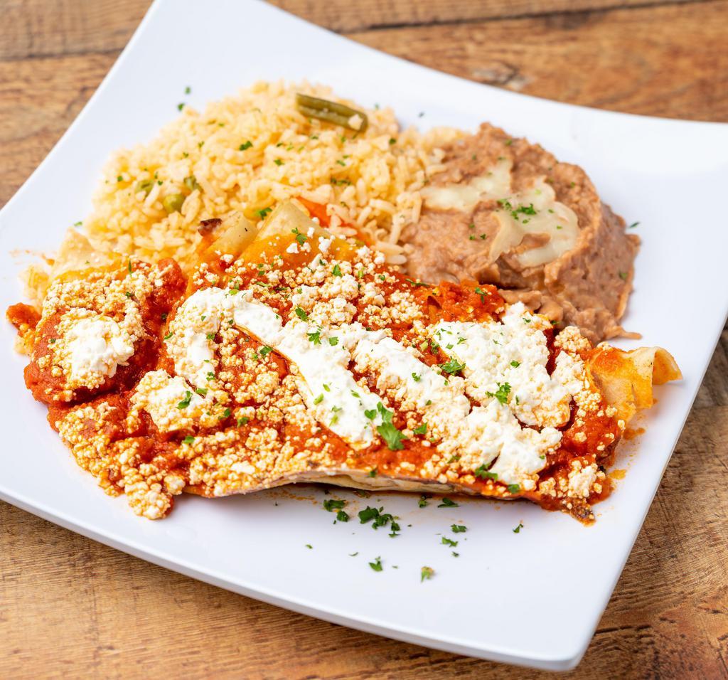 Enchiladas Rojas · 3 tortillas, ranchera sauce stuffed with melted cheese, sour cream, cheese, refried beans and Mexican rice.