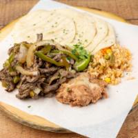 Fajitas de Asada · Stripped steak mixed with green peppers, and onions. Come with rice and beans 4 pieces torti...