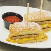 French Toast Breakfast Sandwich · Filled with crispy hash browns, fluffy eggs, cheddar cheese, and a breakfast turkey sausage.