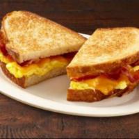 Breakfast Sandwich · Toasted sourdough filled with lettuce, tomatoes, scrambled eggs, and turkey bacon, and chedd...