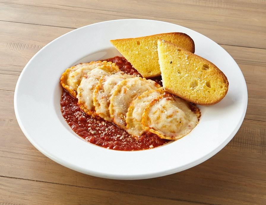 Baked Cheese Ravioli Dinner · Cheese stuffed ravioli baked in our marinara sauce and topped with mozzarella.