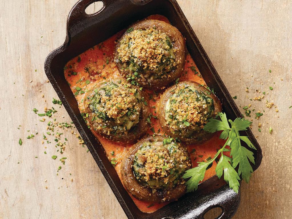 Four-Cheese and Sausage Stuffed Mushrooms · Four mushrooms stuffed with  sausage, spinach, ricotta, parmesan, romano, mozzarella cheese and Italian breadcrumbs served over  our tomato cream sauce  