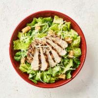 Caesar Salad with Chicken · Now with 50% More Chicken! Wood-grilled chicken served over romaine, croutons, parmesan chee...