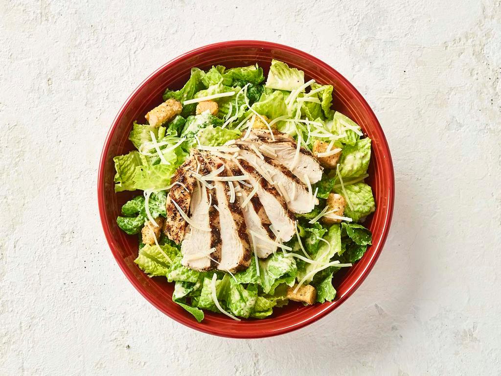 Caesar Salad with Chicken · Now with 50% More Chicken! Wood-grilled chicken served over romaine, croutons, parmesan cheese with our caesar dressing.