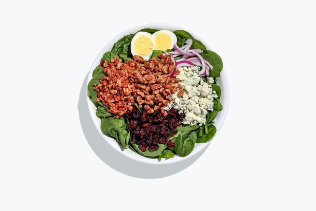 Bleu Berrymore salad · Baby spinach, herb roasted chicken breast, boiled egg, bacon, red onion, dried cranberries, bleu cheese crumbles, topped with spiced pecans, and served with Balsamic Vinaigrette dressing.