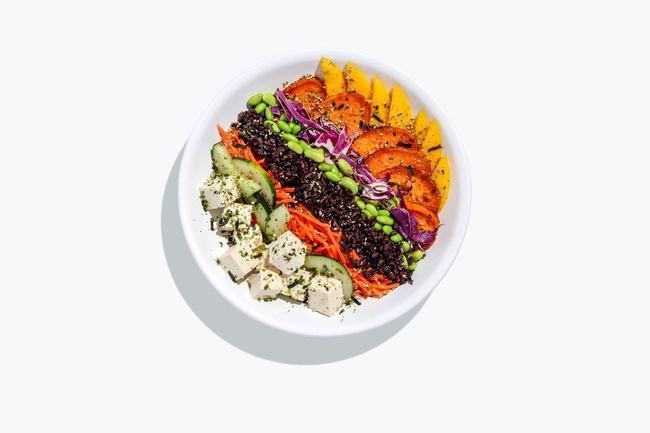 Livin' On The Veg bowl · Forbidden black rice, red cabbage, baked tofu, sweet potato, mango, pickled cucumber, red pepper, edamame, topped with crispy onions, and served with Miso Sesame dressing. VEGAN.