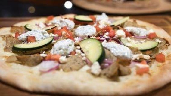 Chicken Gyro Pizza · White pizza sauce, marinated chicken gyro meat, tomatoes, cucumbers, feta cheese and drizzles with classic tzatziki sauce.