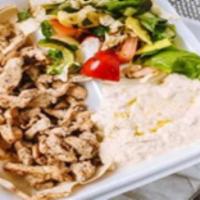Chicken Shawarma Platter · Chicken shawarma served over rice, side of Greek salad and choice of tahini or garlic sauce.