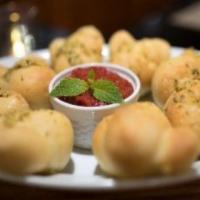 Garlic Knots · 6 knots served with red dipping sauce.